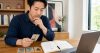 Man using tarot cards alongside a practical decision journal